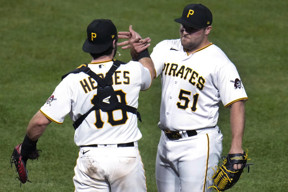 Pittsburgh Pirates relief pitcher David Bednar celebrates with catcher Austin Hedges after the team's 4-2 win over the Cincinnati Reds in a baseball game in Pittsburgh, Friday, April 21, 2023. (AP Photo/Gene J. Puskar)