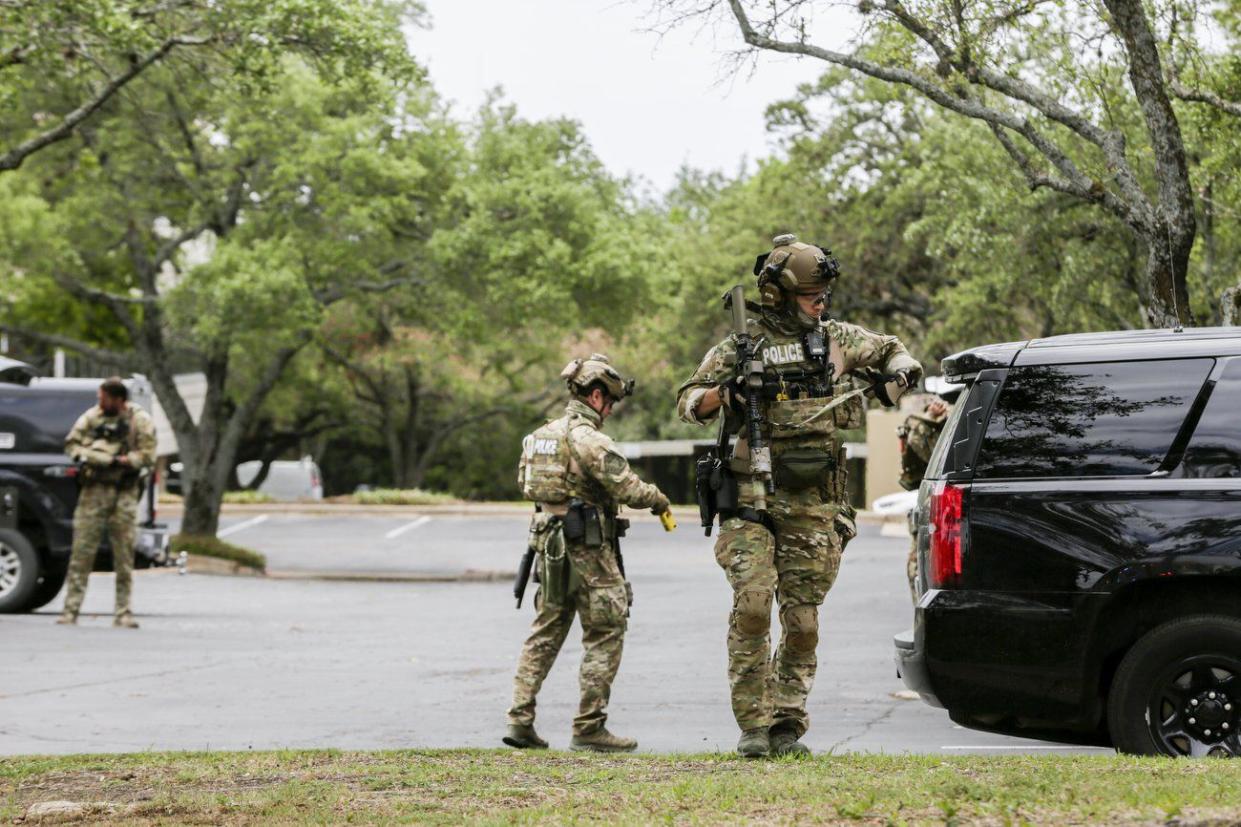 Austin police, SWAT and medical personnel respond to an active shooter situation located at Great Hills Trail in Northwest Austin, Tex. on Sunday, April 18, 2021. Emergency responders say several people have been fatally shot in Austin and that no suspect is in custody.