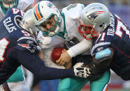 Matt Moore #8 of the Miami Dolphins is sacked by Shaun Ellis #94 of the New England Patriots and teammate Brandon Deaderick #71 in the second half at Gillette Stadium on December 24, 2011 in Foxboro, Massachusetts. (Photo by Jim Rogash/Getty Images)