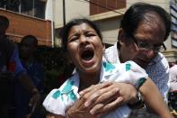 A customer cries as she is evacuated following a shootout between unidentified armed men and the police at the Westgate shopping mall in Nairobi September 21, 2013. (REUTERS/Thomas Mukoya)