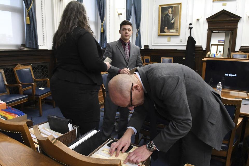 Kyle Rittenhouse stands with defense attorney Natalie Wisco and Corey Chirafisi at the start of his trial at the Kenosha County Courthouse in Kenosha, Wis., on Thursday, Nov. 4, 2021. Rittenhouse is accused of killing two people and wounding a third during a protest over police brutality in Kenosha, last year. (Mark Hertzberg /Pool Photo via AP)