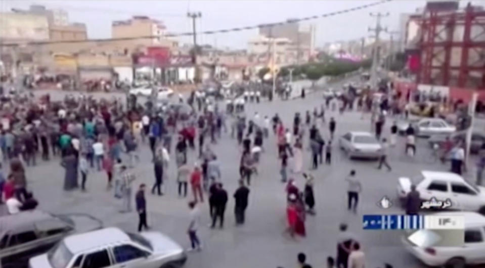 In this Saturday, Nov. 16, 2019 image from video aired by Iran's Islamic Republic of Iran Broadcasting state television channel, protesters gather on a street in Khorramshahr, Iran. Protesters angered by Iran raising government-set gasoline prices by 50% blocked traffic in major cities and occasionally clashed with police Saturday after a night of demonstrations punctuated by gunfire, violence that reportedly killed at least one person. (IRIB via AP)