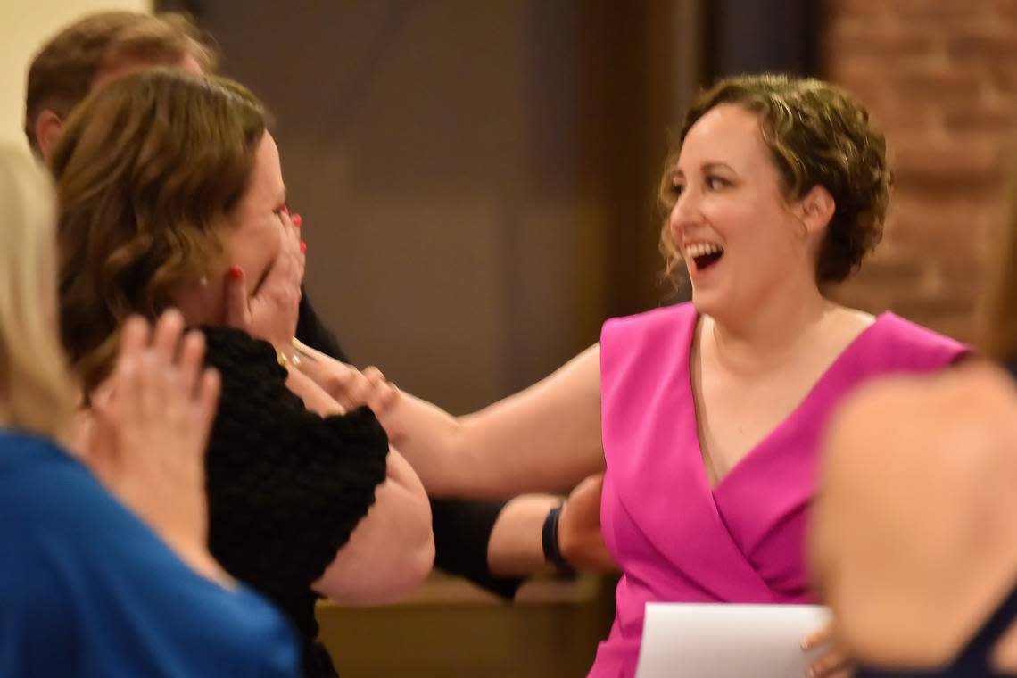 During the Muscogee Educational Excellence Foundation gala May 9, 2024, in the Columbus Convention & Trade Center, Christie Akers, right, of Northside High School reacts to the announcement that she is the Muscogee County School District 2024 Teacher of the Year.