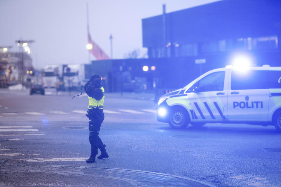 A police officer in the center of Bodø, Northern Norway, during extreme weather, Thursday, Feb. 1, 2024. Residents of central Norway awoke to scenes of havoc and homes without power Thursday, following the country's most powerful storm in more than three decades. (Per-Inge Johnsen/NTB Scanpix via AP)