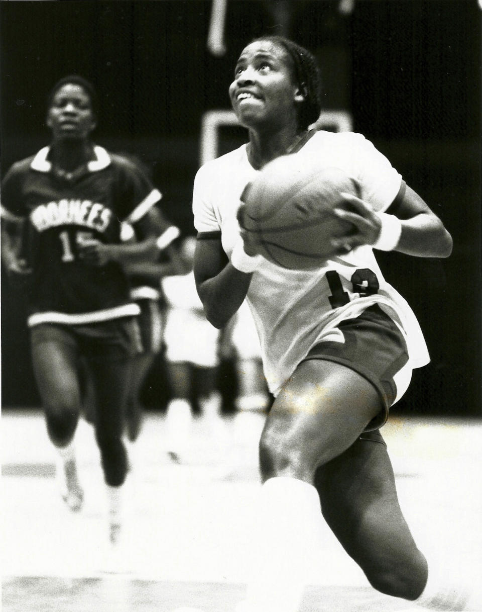 This undated photo provided by Francis Marion University shows women's basketball player Pearl Moore, right, during a basketball game against Voorhees College. Long before Iowa star Caitlin Clark hit her first long-range three or signed her first autograph, Hall of Famer Pearl Moore had already set the scoring standard for women's basketball. Moore began her journey as the game's greatest female scorer in an era when women were not encouraged to play sports. (Francis Marion University via AP)