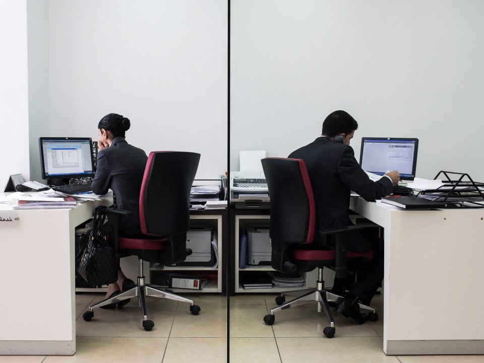 man and woman at desks office