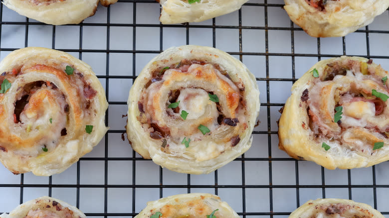 muffuletta pastry pinwheels on rack