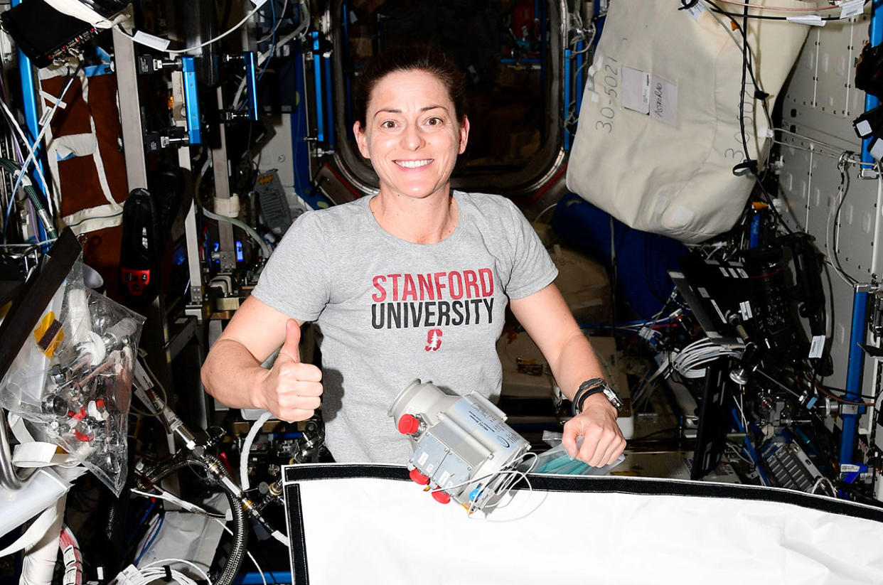  Expedition 68 flight engineer Nicole Mann works on the Four Bed Carbon Dioxide Scrubber (FBCO2), including the installation of Calnetix Technologies' Momentum In-Line Blower (seen floating at center) on the International Space Station, February 2023. 