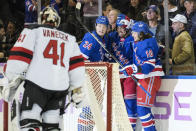 New York Rangers left wing Artemi Panarin (10) celebrates after scoring on New Jersey Devils goaltender Vitek Vanecek (41) in the first period of an NHL hockey game, Monday, Nov. 28, 2022, in New York. (AP Photo/John Minchillo)