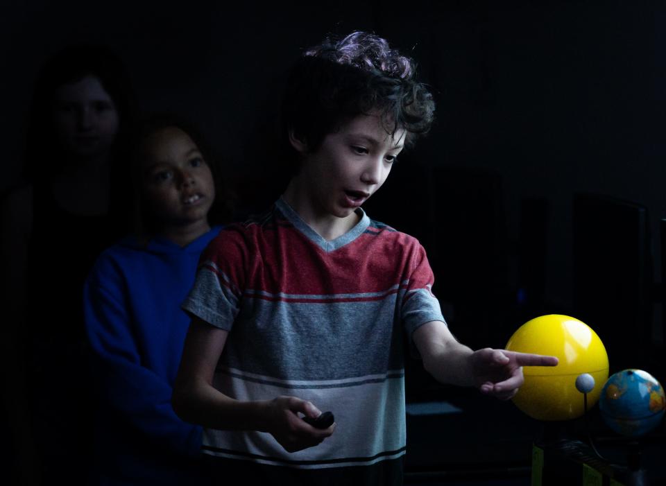 Pfluger Elementary School fifth grader Stevie Jamail-Hayes explains the mechanics of a solar eclipse while giving a presentation to third graders on Tuesday, April 2, 2024 during the Buda elementary school's STEM class.