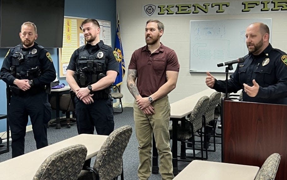 Kent Police Officers, from left, Matt Butcher, Kyle Auckland and Leonard Kunka are recognized by Police Chief Nicholas Shearer for an 2021 incident where the lives of two children were in danger. Auckland and Kunka were both shot during the incident.