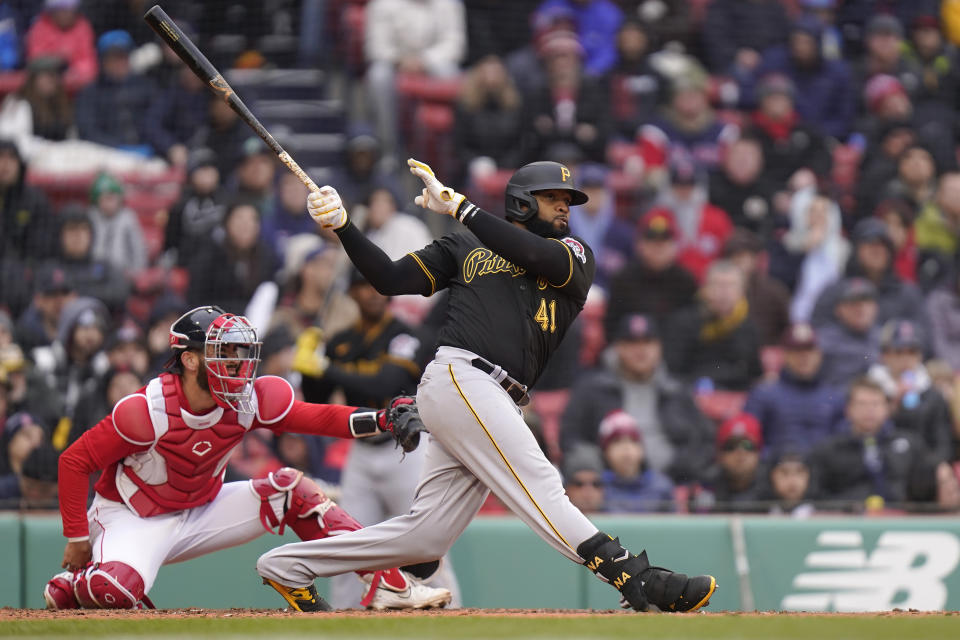 Pittsburgh Pirates' Carlos Santana, right, hits a double allowing Oneil Cruz to score as Boston Red Sox's Connor Wong, left, looks on in the seventh inning of a baseball game, Wednesday, April 5, 2023, in Boston. (AP Photo/Steven Senne)