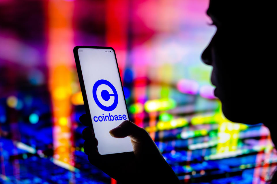 BRAZIL - 2022/04/12: In this photo illustration, a woman holds a smartphone with the Coinbase logo displayed on the screen. (Photo Illustration by Rafael Henrique/SOPA Images/LightRocket via Getty Images)