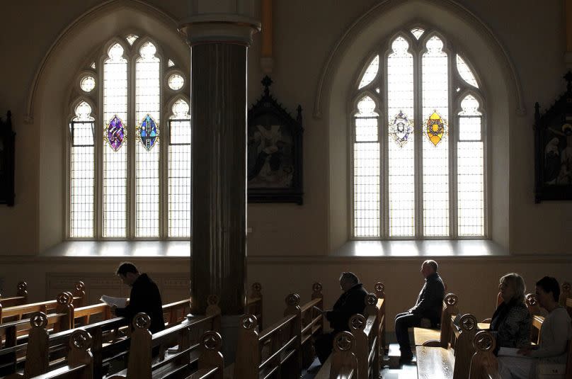 Roman Catholics listen to Bishop Noel Treanor during mass at St. Peter's Roman Catholic Cathedral, in West Belfast, Northern Ireland.