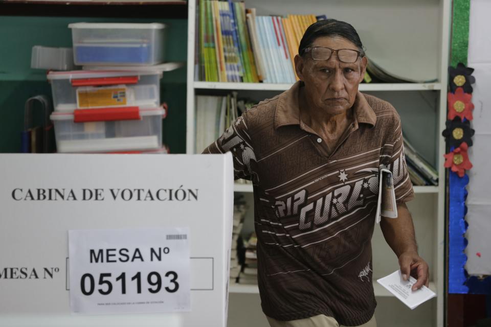 A man leaves a voting booth after voting in the congressional elections at a public school at the Villa El Salvador shantytown of Lima, Peru, Sunday, Jan. 26, 2020. Peruvians are voting to elect 130 new members of the congress that will legislate for only one year, in place of the congress that was dissolved by president Martin Vizacarra in September 2019. (AP Photo/Martin Mejia)