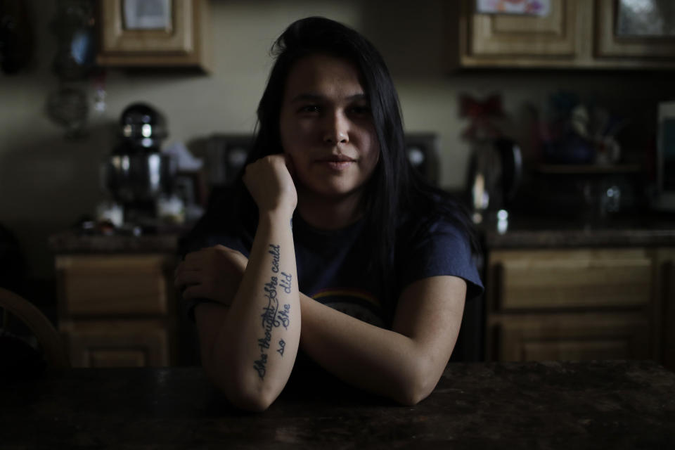 In this Feb. 16, 2019, photo, Deidre Levi sits at the table of her grandmother's home in the Native Village of St. Michael, Alaska. Levi says she spoke up about being sexually assaulted because she wanted to be a role model for girls in Alaska. (AP Photo/Wong Maye-E)