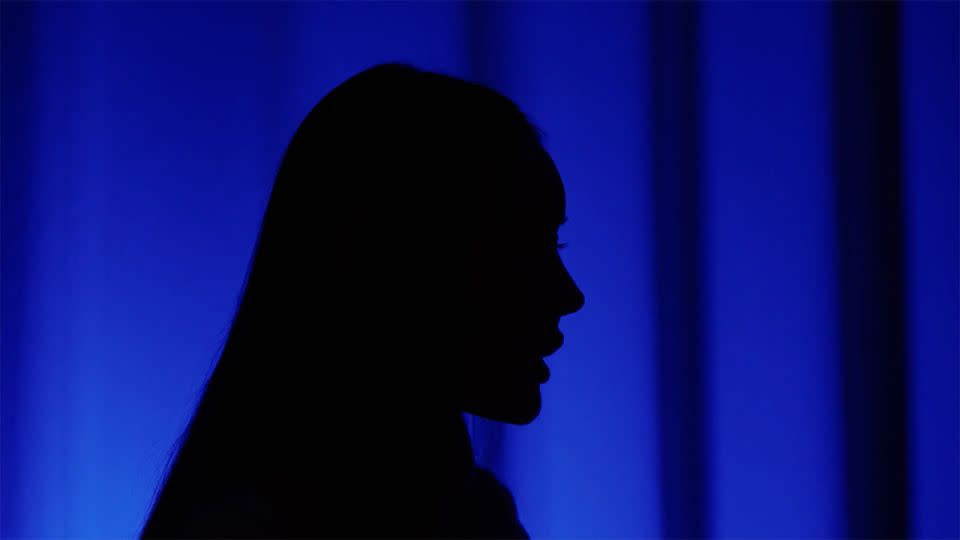 A silhouette of Yu, who first met her host in January 2023. More than a year later, she is still in debt and resorting to sex work to pay her bills. - Daniel Campisi/CNN