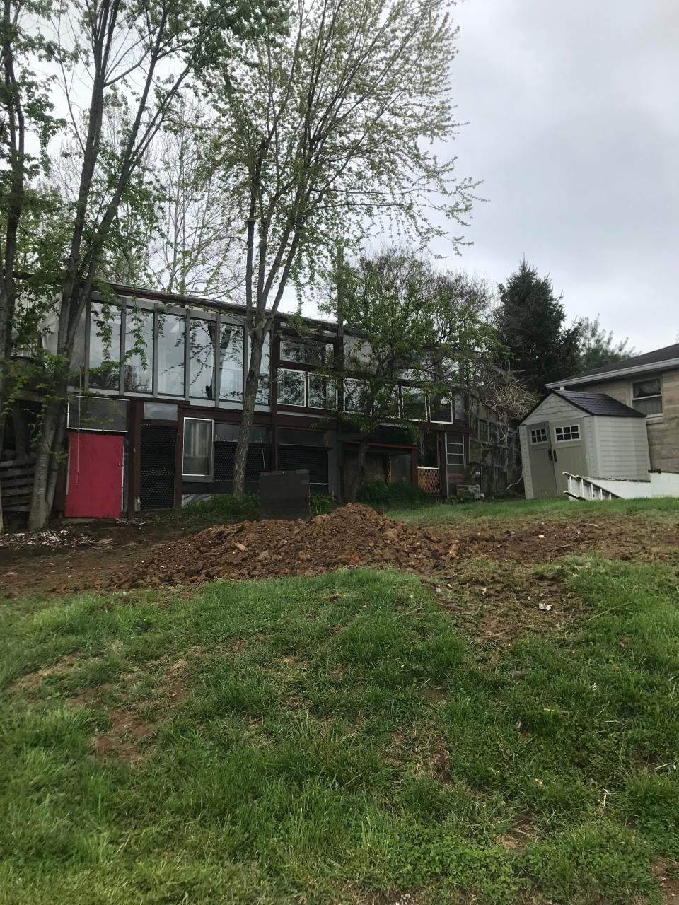 The side of Robert Lowers house, where he's built walls from recycled glass products, including shower doors and beer bottles.