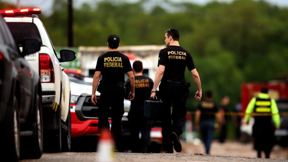 Police deploy at Vila do Castelo port in Braganca, Brazil, on April 14, after fishermen reported spotting a boat laden with decomposing corpses off the coast of Para state on Saturday. - Raimundo Pacco/AP