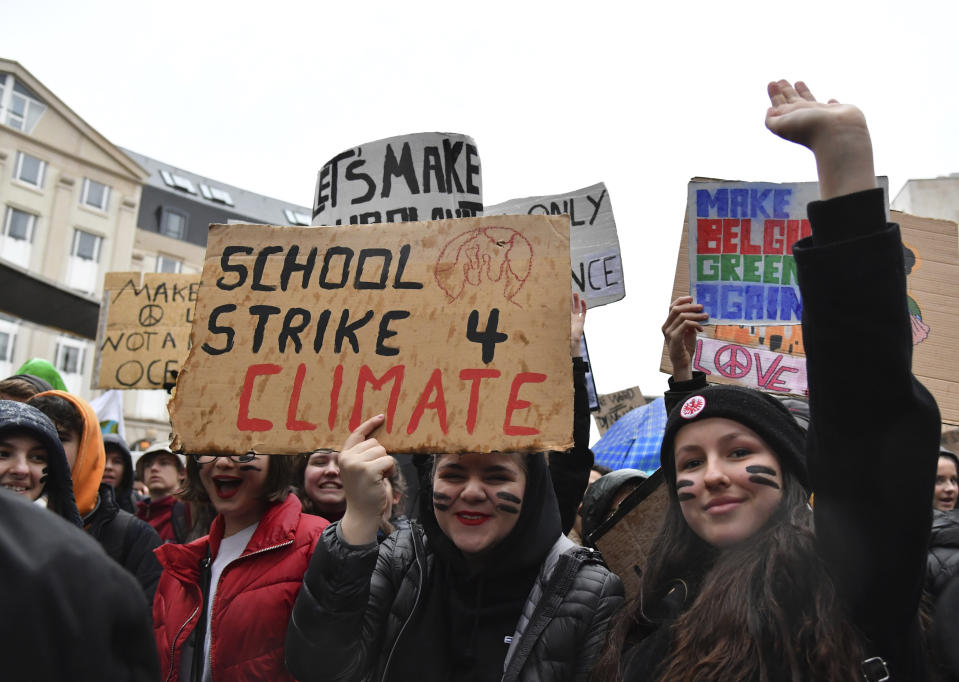 Students and others hold up placards with climate messages during a demonstration against climate change in Brussels, Thursday, Jan. 17, 2019. Thousands of students as part of the Youth for Climate movement took time off school Thursday to call for stronger action against climate change. (AP Photo/Geert Vanden Wijngaert)