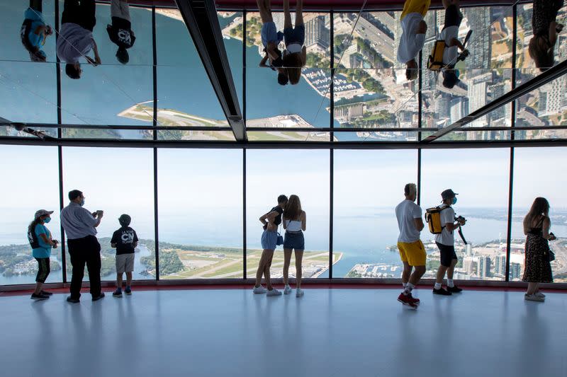 Visitors view panoramic city scenes from the CN Tower in Toronto