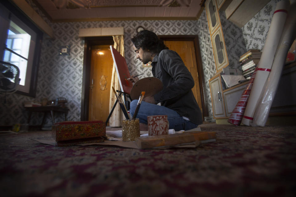 Kashmiri artist Tabish Haider paints inside his house in Srinagar, Indian controlled Kashmir, July 22, 2020. A year after India ended disputed Kashmir's semi-autonomous status and downgraded it to a federally governed territory, authorities have begun issuing residency and land ownership rights to outsiders for the first time in almost a century. Many Kashmiris like Haider view the move as the beginning of settler colonialism aimed at engineering a demographic change in India’s only Muslim-majority region. “They have recently introduced a law which is a domicile law, which basically says that we as Kashmiris, who have been living here for past many generations, they have to prove their own identity in their own land. So how can a piece of paper prove my identity in my own land? Haider asked. (AP Photo/Mukhtar Khan)