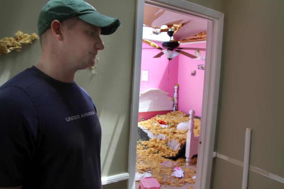 Mike Skinner stands in the hallway of his home, Tuesday, April 29, 2014 where he and his family sought shelter outside his daughters' rooms during a storm in Decatur, Miss. (AP Photo/The Meridian Star, Paula Merritt)