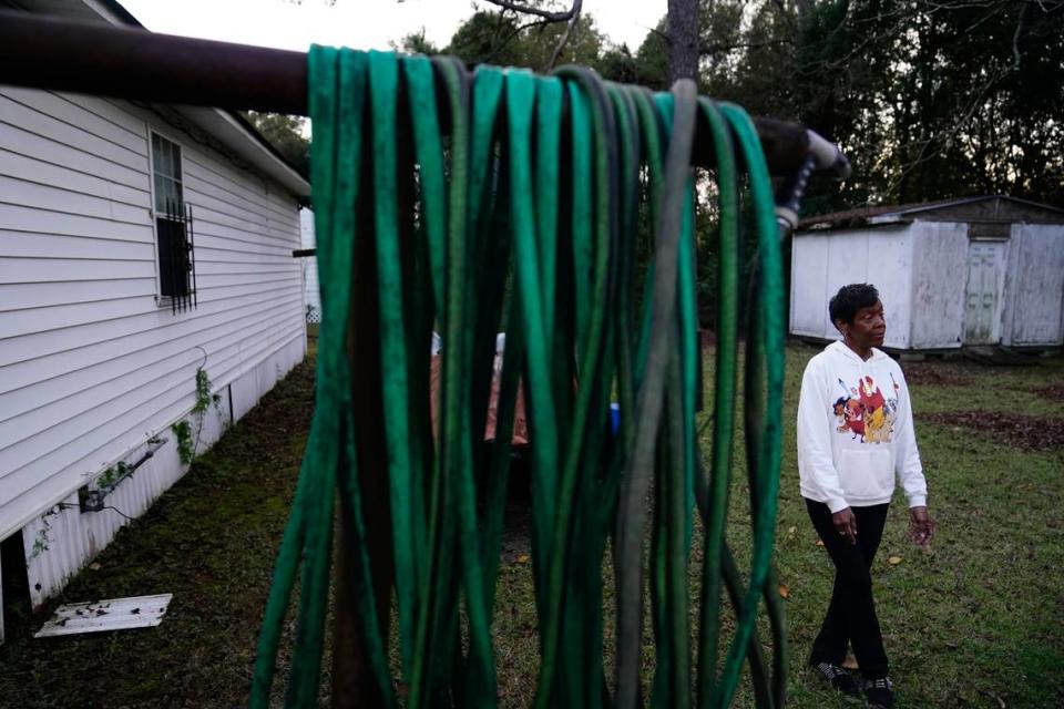 Angela Adams stands in the backyard of her home of 30 years in the Alabama Village neighborhood, in Prichard, Ala. There is talk of seizing residents’ property and paying them to move to help stem the city’s water loss and create opportunities for redevelopment.