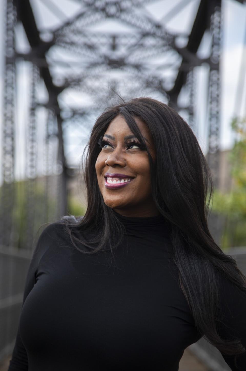 A smiling woman in a black turtleneck