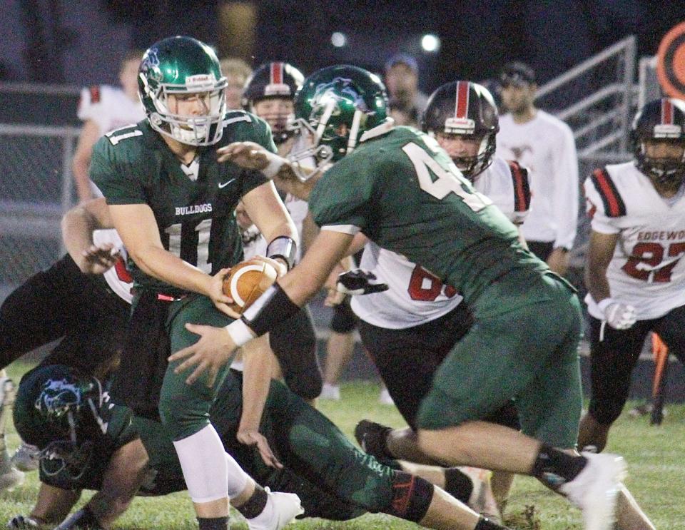 Monrovia junior Eli Wagner fakes a handoff to sophomore Brayton Belcher during Friday's game against Edgewood. (Melissa Dillon/Correspondent)