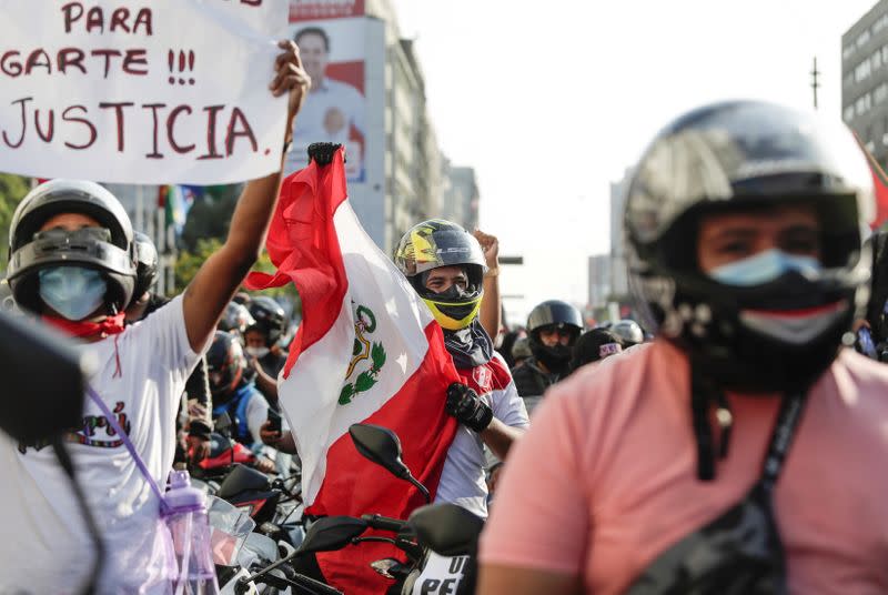 People react after Peru's interim President Manuel Merino announced his resignation, in Lima