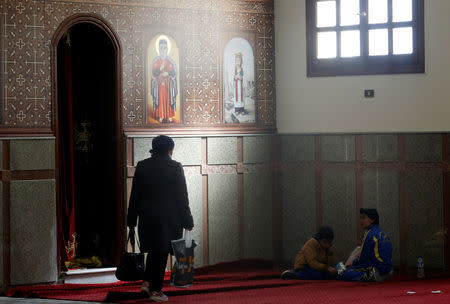 Christian family from Al-Arish city North Sinai’s Governorate capital after the escalation of a campaign targeting Christians by Islamic State militants last week, take a rest after arriving inside the Saint Church in Ismailia, northeast of Cairo, Egypt February 27, 2017. Picture taken February 27, 2017. REUTERS/Amr Abdallah Dalsh