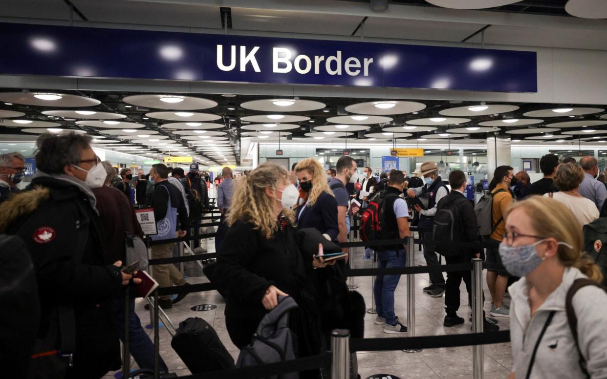 Arriving passengers dealing with long queues at Heathrow earlier this summer - REUTERS