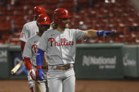 Philadelphia Phillies' Bryce Harper waves to teammates sitting in the stands after hitting a three run home run against the Boston Red Sox during the sixth inning of a baseball game Tuesday, Aug. 18, 2020, at Fenway Park in Boston. (AP Photo/Winslow Townson)