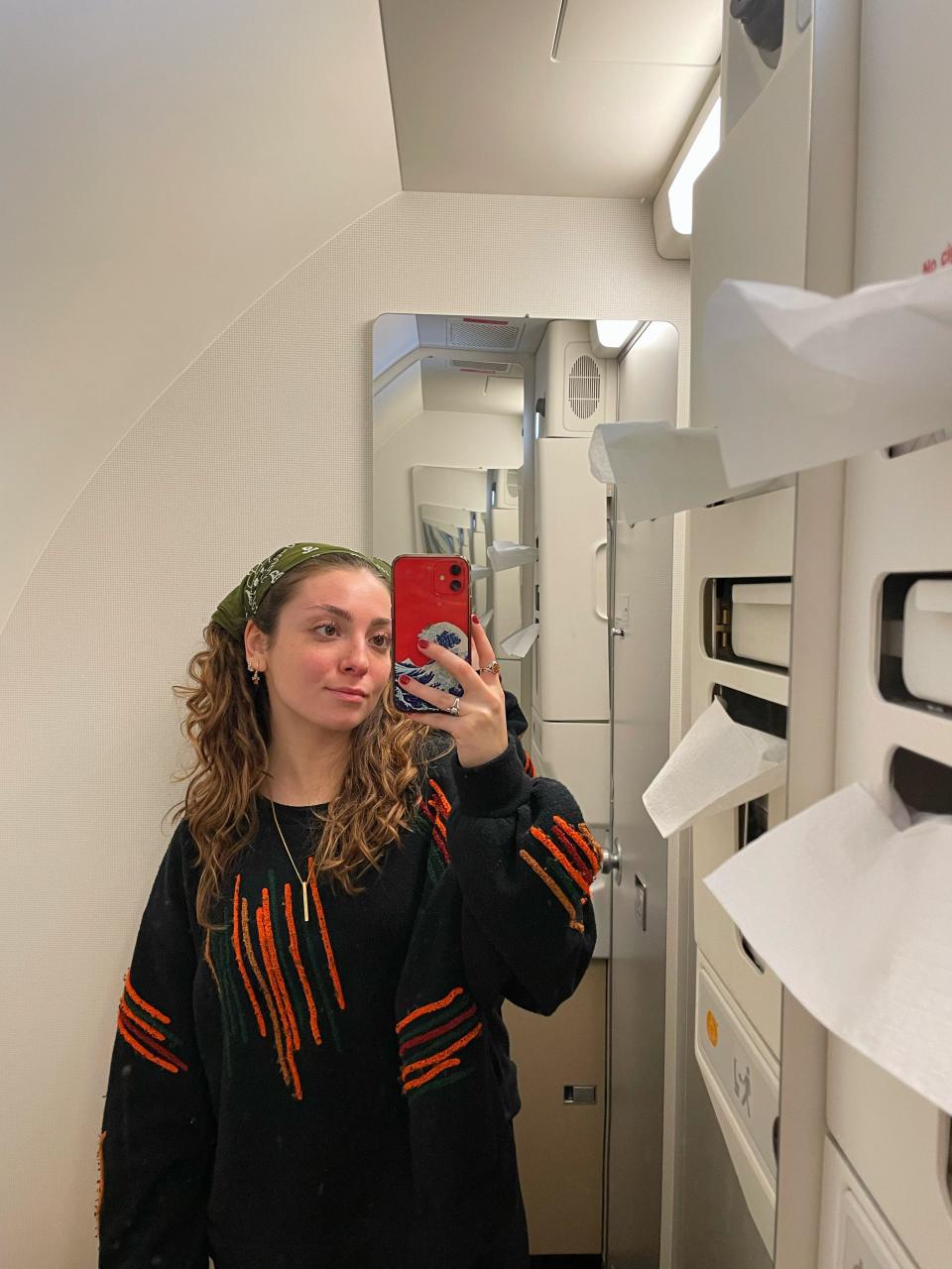 The author taking a photo in one of the bathroom's mirror Asia London Palomba PLAY Airlines review