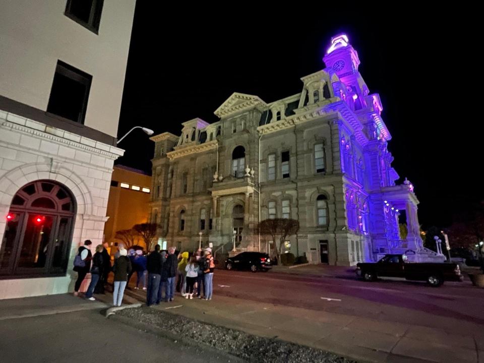 Ghost tour guests observe the Muskingum County Courthouse.