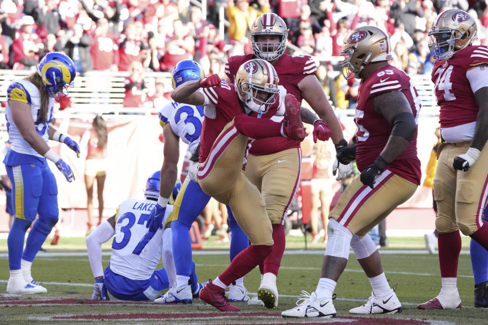 San Francisco 49ers wide receiver Ronnie Bell, middle, celebrates with teammates after scoring against the Los Angeles Rams during the first half of an NFL football game in Santa Clara, Calif., Sunday, Jan. 7, 2024. (AP Photo/Loren Elliott)