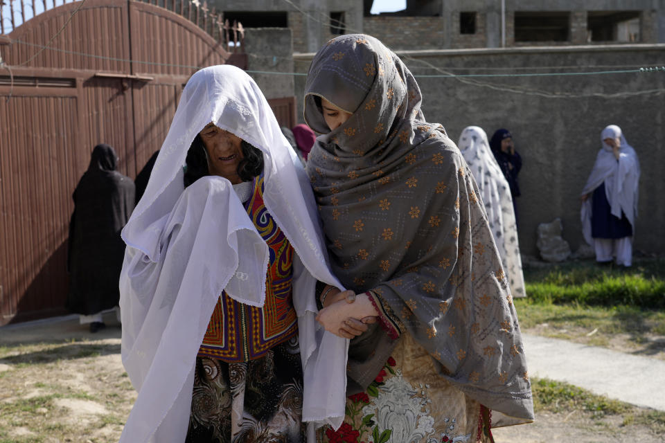 The family of a 19-years old girl who was victim of a suicide bomber mourns, in Kabul, Afghanistan, Friday, Sept. 30, 2022. A Taliban spokesman says a suicide bomber has killed several people and wounded others at an education center in a Shiite area of the Afghan capital. The bomber hit while hundreds of teenage students inside were taking practice entrance exams for university, a witness says. (AP Photo/Ebrahim Noroozi)