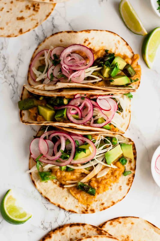 <p>Eat Love Eats</p><p>These vegan tacos feature refried cannellini beans, plenty of spring veggies and all the toppings!</p><p><strong>Get the recipe: <a href="https://www.eatloveeats.com/vegan-tacos-refried-cannellini-beans-asparagus/" rel="nofollow noopener" target="_blank" data-ylk="slk:Vegan Tacos with Refried Cannellini Beans and Asparagus;elm:context_link;itc:0;sec:content-canvas" class="link rapid-noclick-resp"><em>Vegan Tacos with Refried Cannellini Beans and Asparagus</em></a></strong></p>