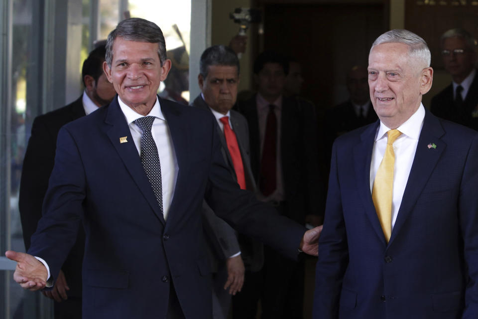 Brazil's Defense Minister Joaquim Silva e Luna, left, walks with U.S. Secretary of Defense Jim Mattis, after their meeting in Brasilia, Brazil, Monday, Aug. 13, 2018. Mattis has spent six days visiting South American countries, including Brazil, Argentina, Chile and Colombia. (AP Photo/Eraldo Peres)