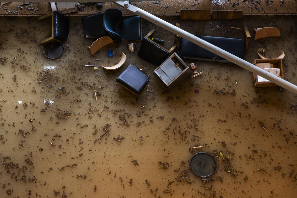 Restaurants tables at a restaurant scatter in a flooded shopping mall following heavy rainstorms in Hong Kong, Friday, Sept. 8, 2023. Rain pouring onto Hong Kong and southern China overnight flooded city streets and some subway stations, halting transportation and forcing schools to close Friday. (AP Photo/Louise Delmotte)