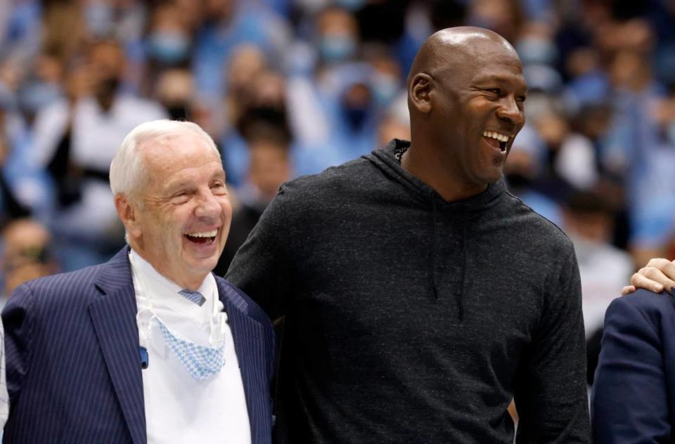 Roy Williams laughs with Michael Jordan as the 1981-82 North Carolina national champion basketball team is honored during UNC’s 100-80 victory over N.C. State at the Smith Center in Chapel Hill, N.C., Saturday, Jan. 29, 2022.