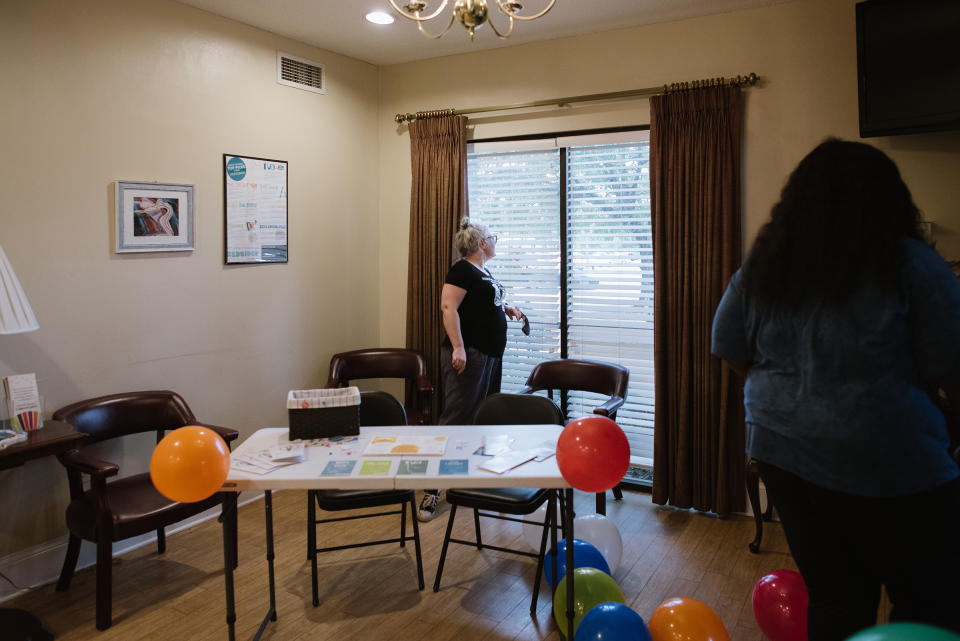 Robin Marty looks out the window to see if their promotion of the emergency-contraception fair brought out any protesters on July 22.<span class="copyright">Lucy Garrett for TIME</span>