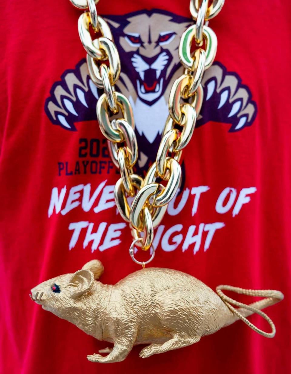 Florida Panthers fan Michael Bejerano, 43, wears a chain with a golden rat as he arrives to a watch party at the Amerant Bank Arena.