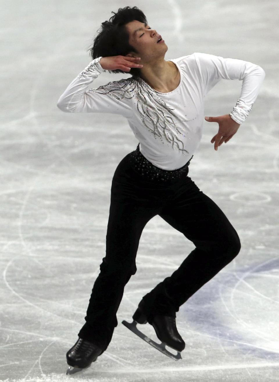Tatsuki Machida of Japan performs during a men's short program of the World Figure Skating Championships in Saitama, near Tokyo, Wednesday, March 26, 2014. (AP Photo/Koji Sasahara)