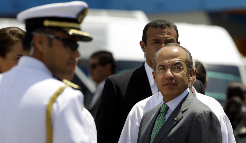 Mexico's President Felipe Calderon, right, looks upon his arrival at the Jose Marti airport in Havana, Cuba, Wednesday, April 11, 2012. Calderon is on a two-day official visit to Cuba. (AP Photo/Javier Galeano)