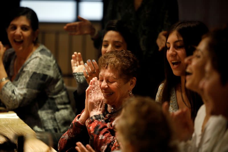 Holocaust survivor Artemis Miron, 91, reacts while celebrating her birthday with family members at a restuarant in Yehud, Israel