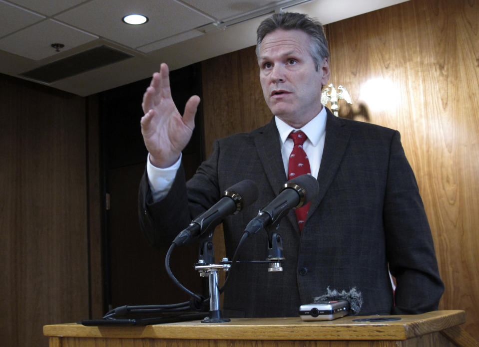 Alaska Gov. Mike Dunleavy speaks to reporters on Wednesday, Feb. 19, 2020, in Juneau, Alaska. Dunleavy has proposed giving Alaskans an additional roughly $1,300 from the state's oil wealth fund on top of the roughly $1,600 they received last fall that he says in keeping with a formula in state law. The formula has not been followed in recent years amid a budget deficit. (AP Photo/Becky Bohrer)