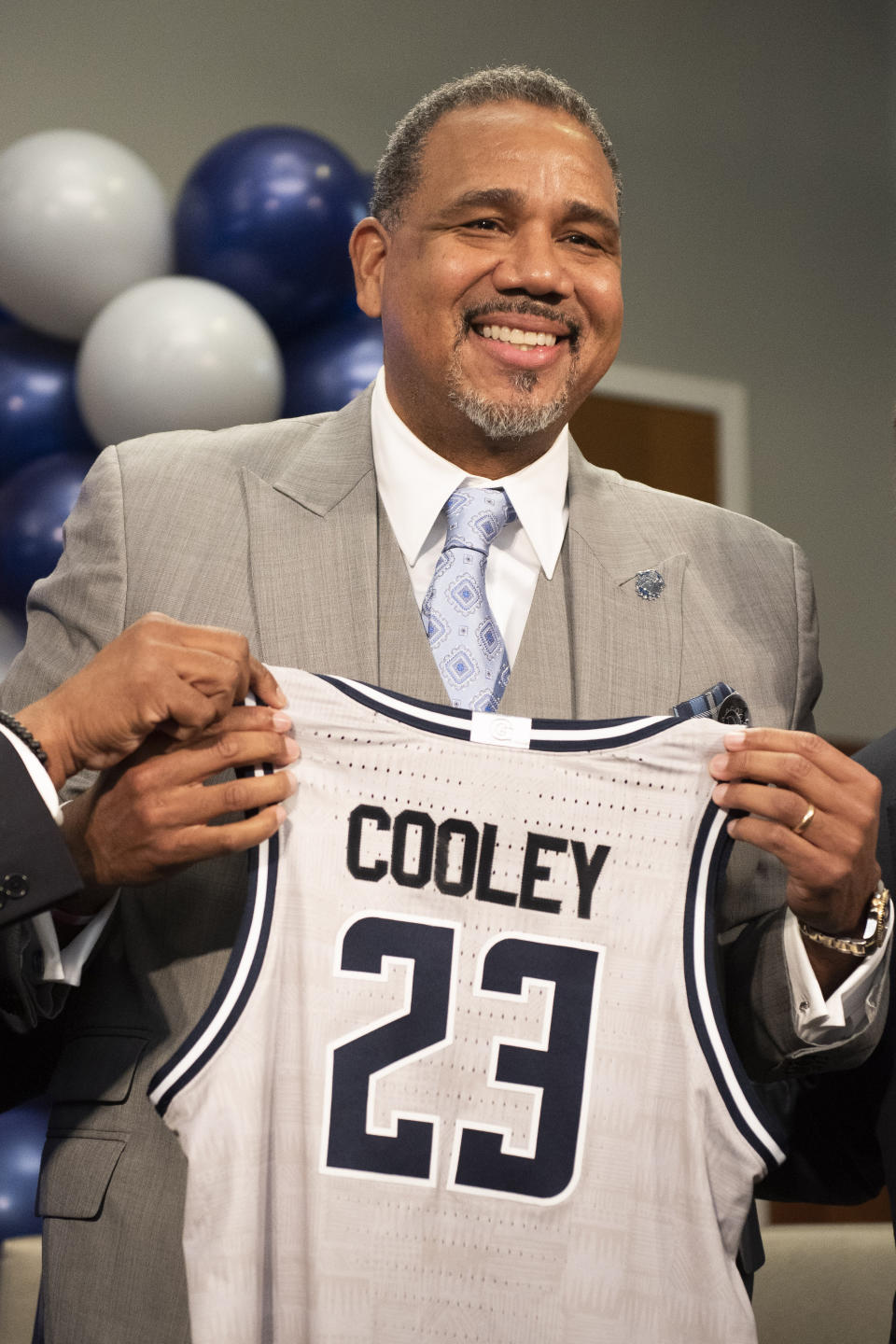 New Georgetown NCAA college basketball head coach Ed Cooley is presented with a jersey during an introductory press conference in Washington, Wednesday, March 22, 2023. (AP Photo/Cliff Owen)