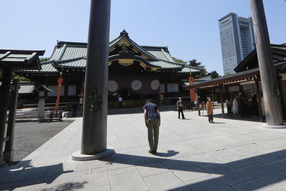 A worshipper bows at Yasukuni Shrine in Tokyo, Wednesday, April 21, 2021, the first day of the annual Spring Rites, the Shinto shrine’s biannual festival honoring the war dead. (AP Photo/Koji Sasahara)